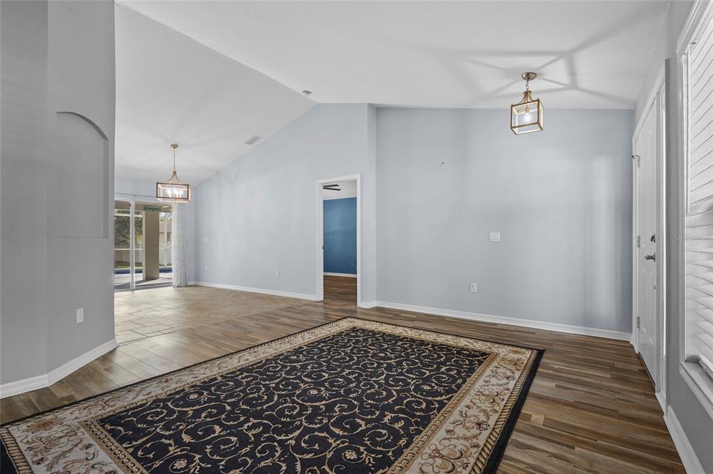 15105 Gulistan Avenue Port Charlotte, FL 33953 - Photo 9 of 39 a view of an empty room with wooden floor and a window