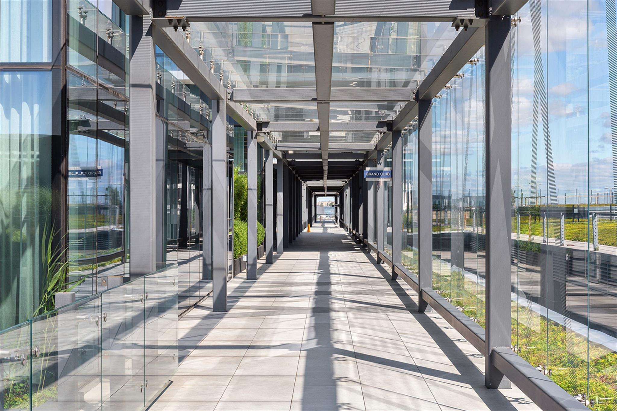 131-01 40 Road, Unit 11M Queens, NY 11354 - Photo 10 of 12 a view of staircase with a rug