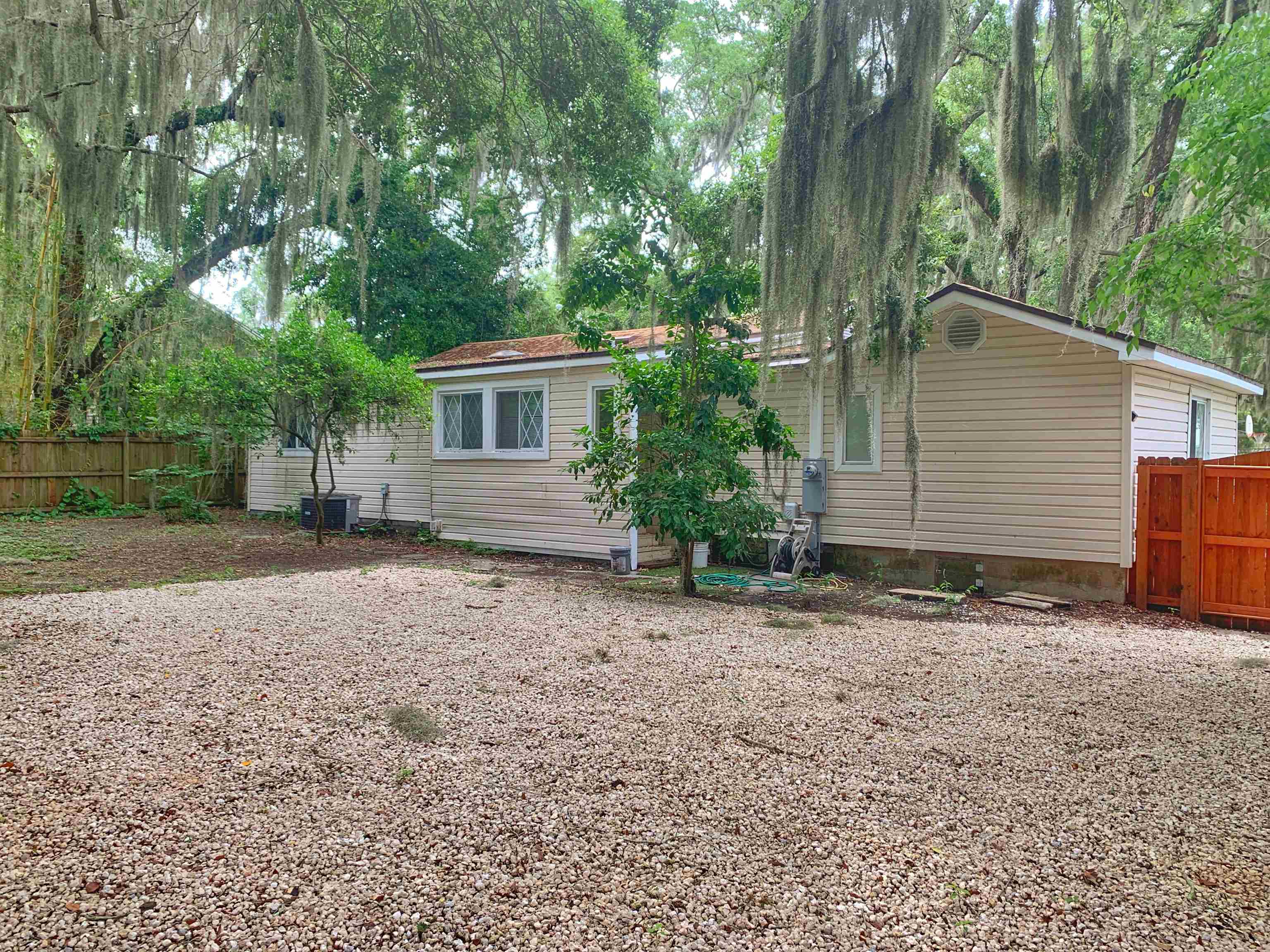 20 Macaris Street St. Augustine, FL 32084 - Photo 25 of 29 front view of a house with a yard and an trees