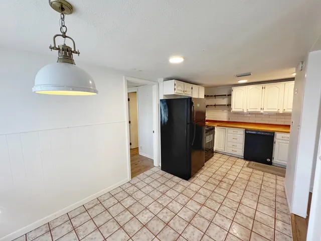 a kitchen with stainless steel appliances a refrigerator and a stove top oven
