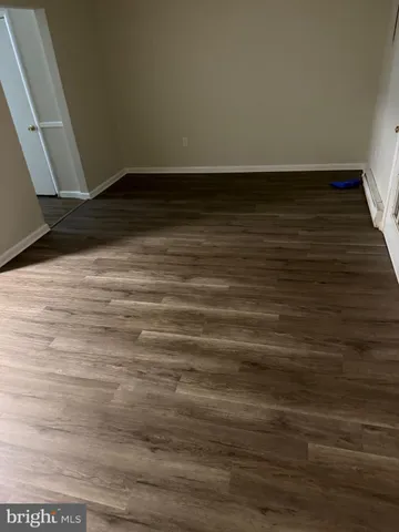 a view of room with wooden floor