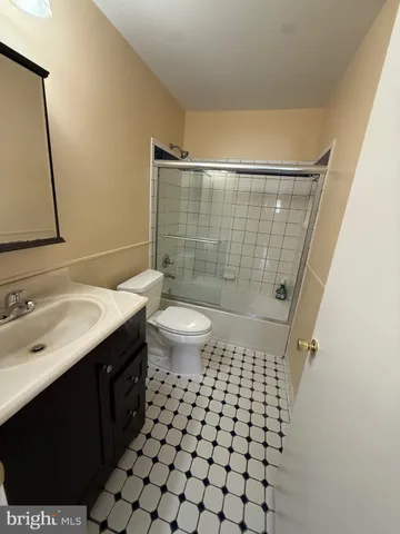 a bathroom with a sink a toilet a shower and a mirror