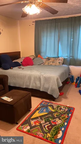 a bedroom with a bed and a lamp