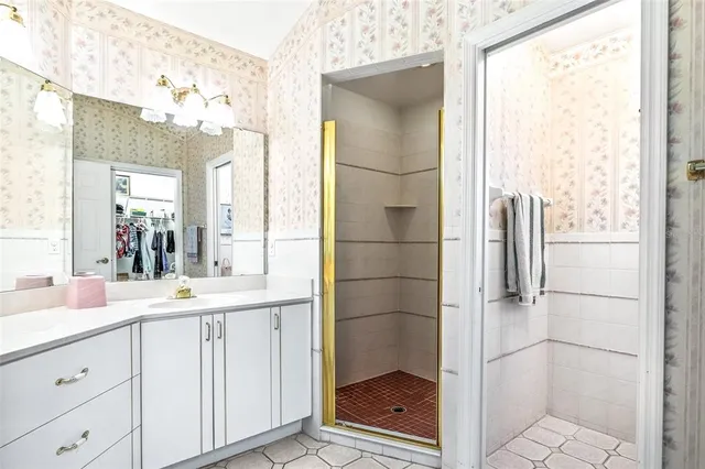 a bathroom with a shower sink and mirror