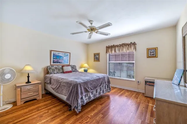 a bedroom with a bed and wooden floor