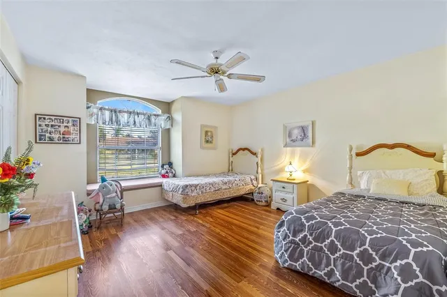 a bedroom with furniture and a large window