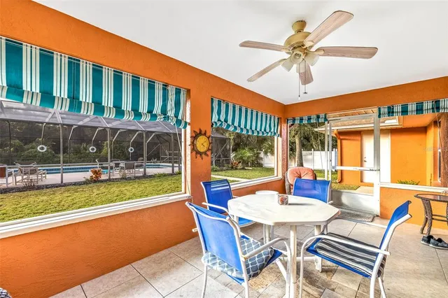 a view of a patio with a table chairs and a swimming pool