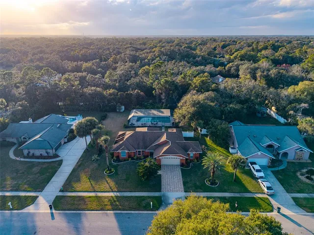 an aerial view of residential houses with outdoor space and parking