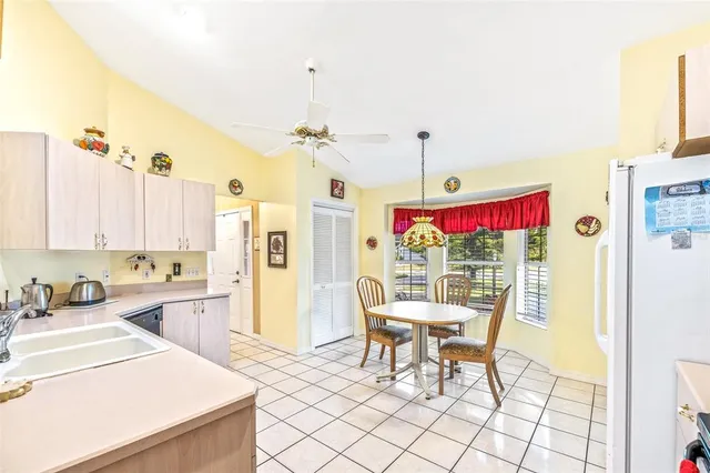 a view of a kitchen with a dining table chairs and sink