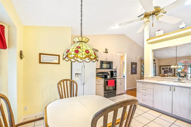a bedroom with a bed table and chairs