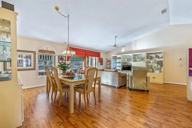 a dining room with furniture window and wooden floor