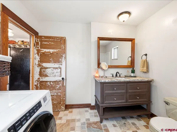 a kitchen with a refrigerator and a stove top oven