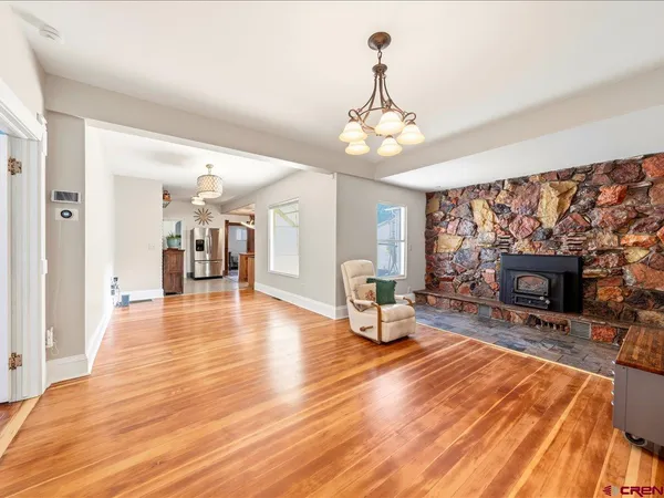 a living room with couch and a wooden floor
