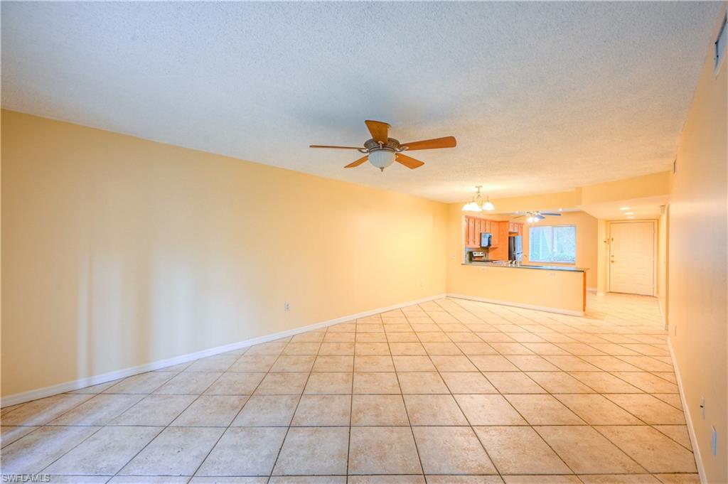 5685 Whitaker Road, Unit C101 Naples, FL 34112 - Photo 5 of 22 a view of a livingroom with a staircase
