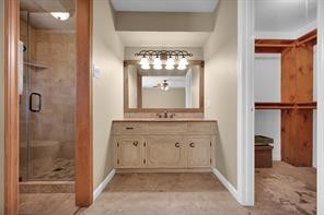 10235 White Rock Road Conroe, TX 77306 - Photo 12 of 25 a bathroom with a double vanity sink mirror and shower
