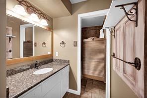 10235 White Rock Road Conroe, TX 77306 - Photo 15 of 25 a bathroom with a granite countertop sink and a mirror