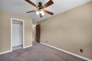 10235 White Rock Road Conroe, TX 77306 - Photo 16 of 25 an empty room with a chandelier fan and a chandelier fan