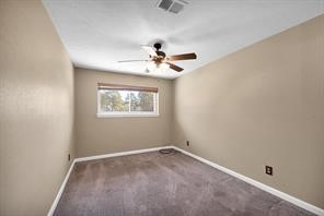 10235 White Rock Road Conroe, TX 77306 - Photo 17 of 25 an empty room with a window and a ceiling fan