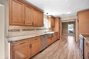 10235 White Rock Road Conroe, TX 77306 - Photo 2 of 25 a spacious bathroom with a granite countertop sink and a large mirror