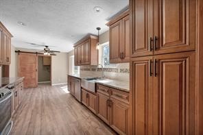 10235 White Rock Road Conroe, TX 77306 - Photo 5 of 25 a kitchen with stainless steel appliances granite countertop a refrigerator a sink dishwasher and wooden cabinets