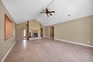 10235 White Rock Road Conroe, TX 77306 - Photo 10 of 25 an empty room with windows and fireplace