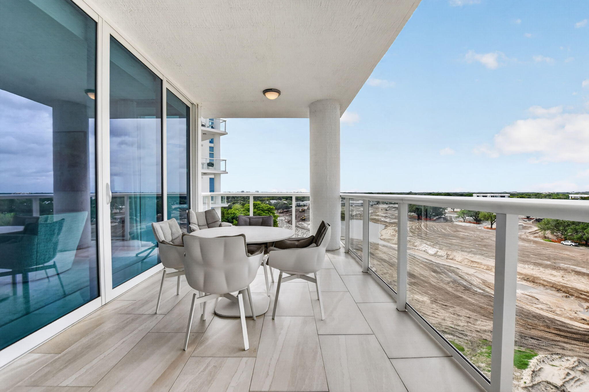 20155 Boca W Drive, Unit B701 Boca Raton, FL 33434 - Photo 5 of 78 a view of a balcony with chairs and wooden floor