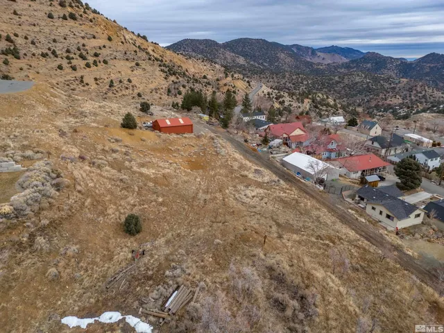 an aerial view of residential houses with city view