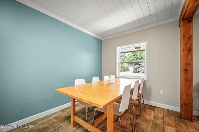 a view of a dining room with furniture and a window