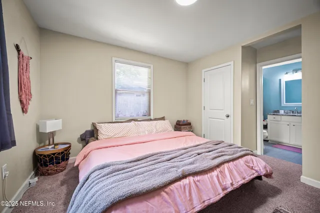 a bedroom with a bed and a view of bathroom