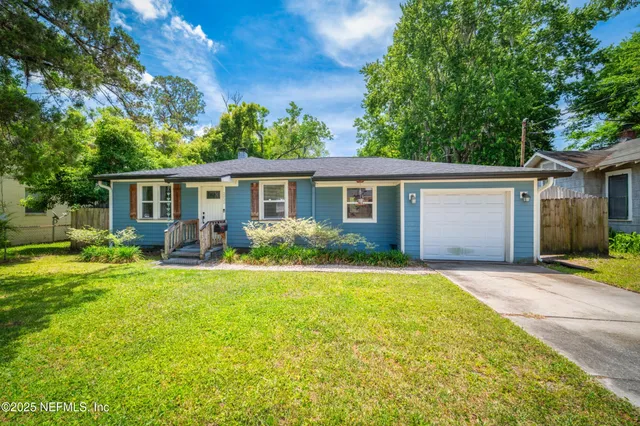 front view of the house and a yard with trees