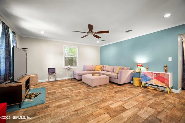 a bedroom with furniture and a flat screen tv