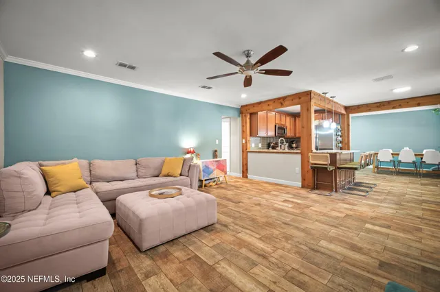 a living room with furniture and kitchen view