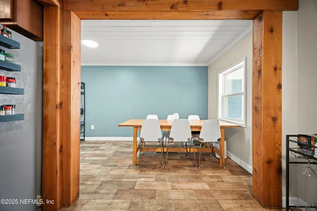 a view of a very nice looking dining room with a table and chairs