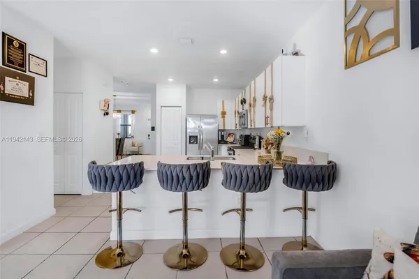 a view of kitchen with table and chairs