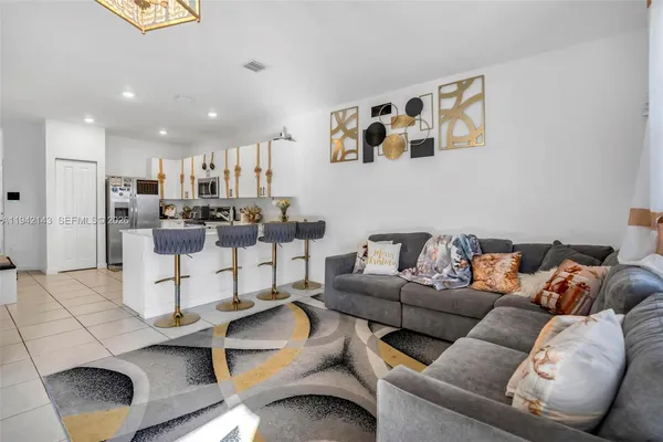 a living room with furniture and kitchen view