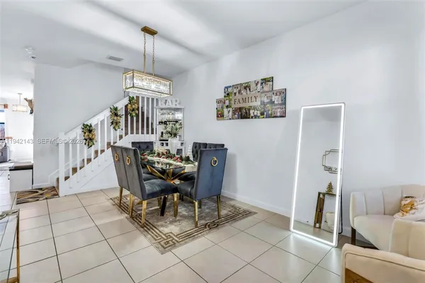 a dining room with furniture and a chandelier