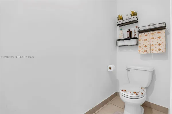 a view of bathroom with a toilet and a view of bathroom