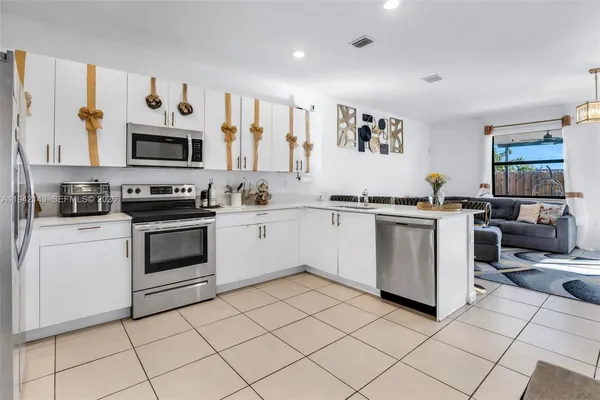 a kitchen with a stove top oven and cabinets