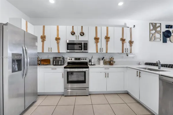 a kitchen with stainless steel appliances a stove sink and refrigerator