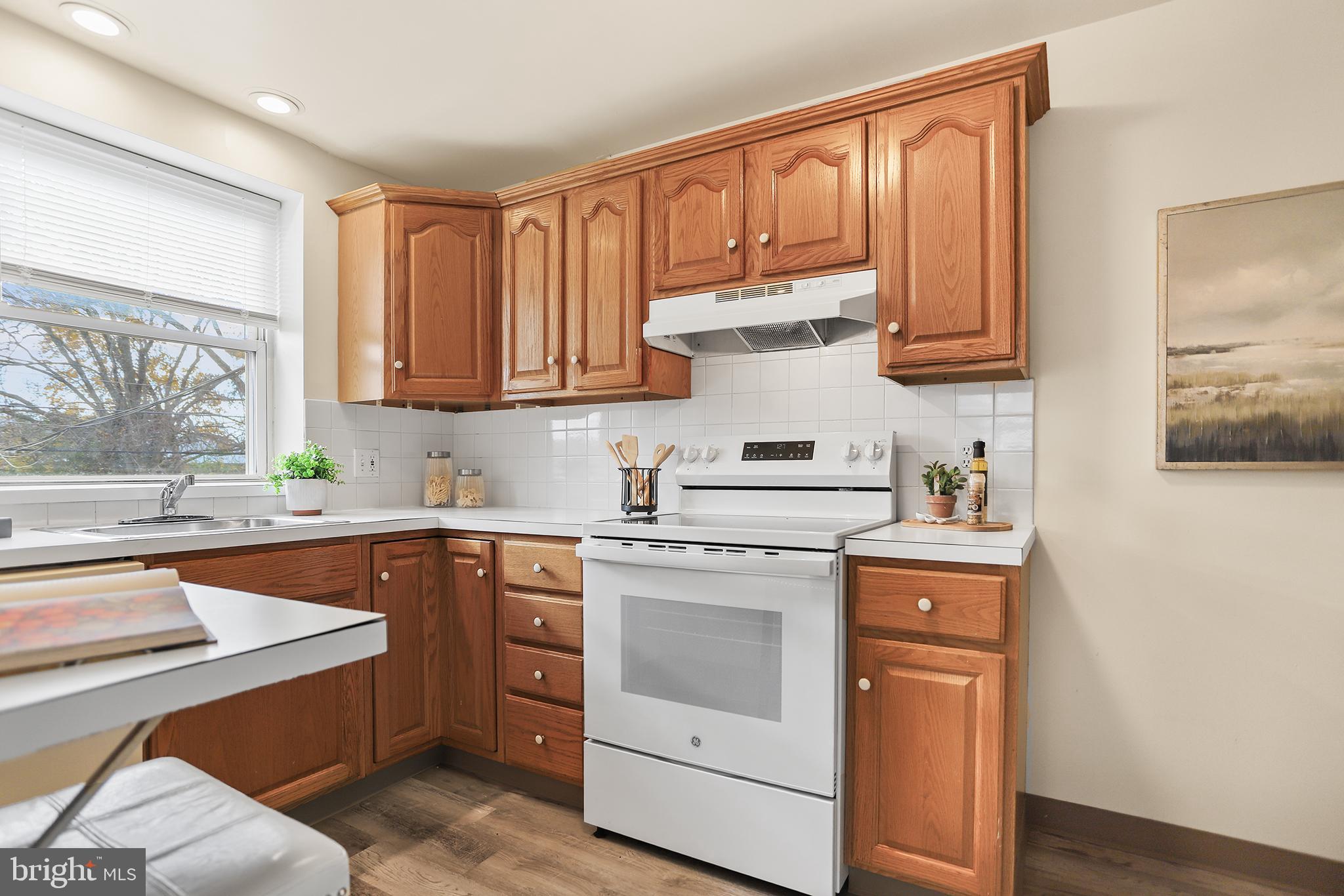 357 Cedar Avenue Holmes, PA 19043 - Photo 8 of 20 a kitchen with granite countertop a sink stainless steel appliances and cabinets