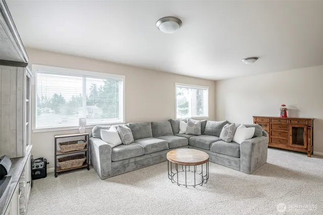 a bedroom with a bed and large windows
