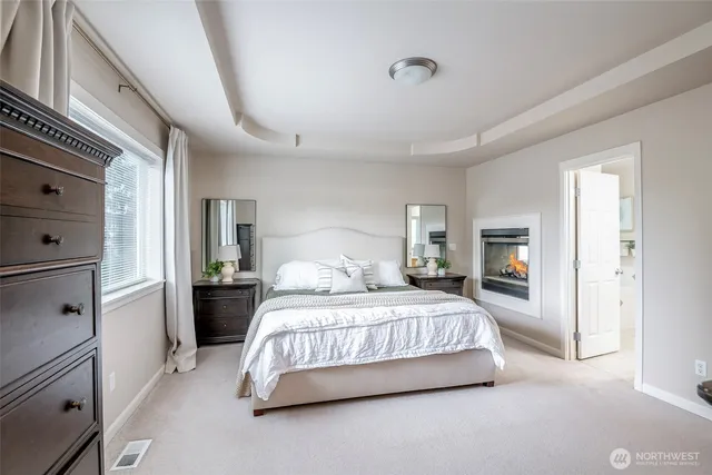 a bedroom with a bed and a television