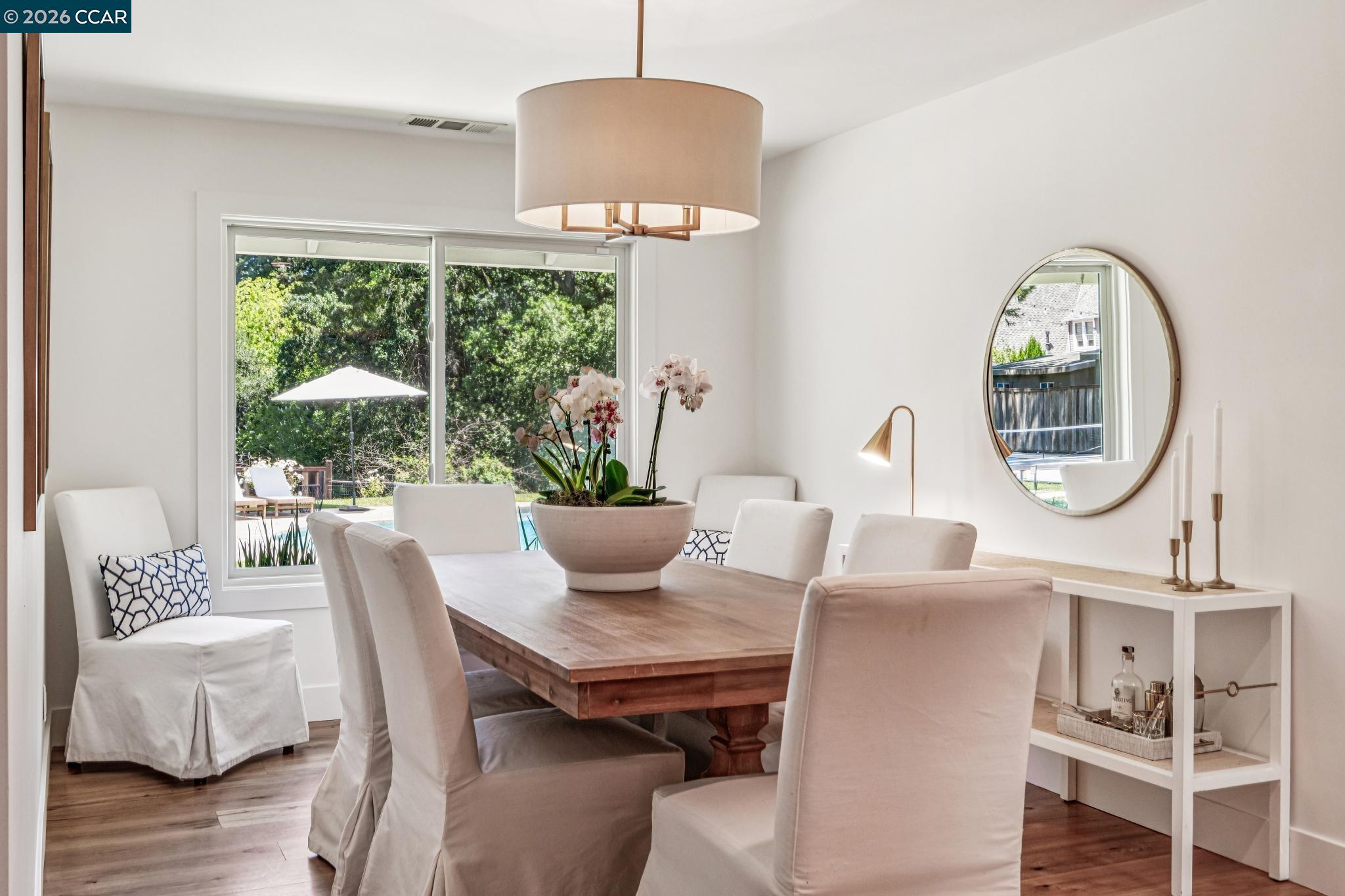 2941 Roundhill Road Alamo, CA 94507 - Photo 17 of 83 a dining room with furniture a chandelier and wooden floor