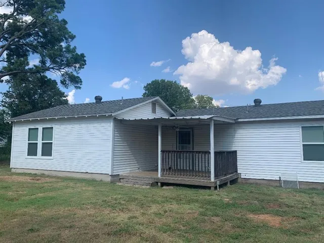 a view of backyard of house with deck