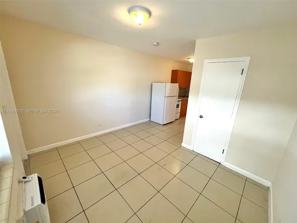 a view of a utility room and empty room