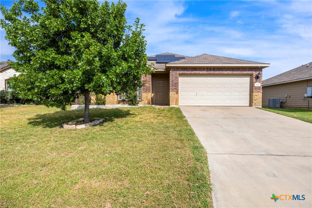 a view of a house with a yard and garage