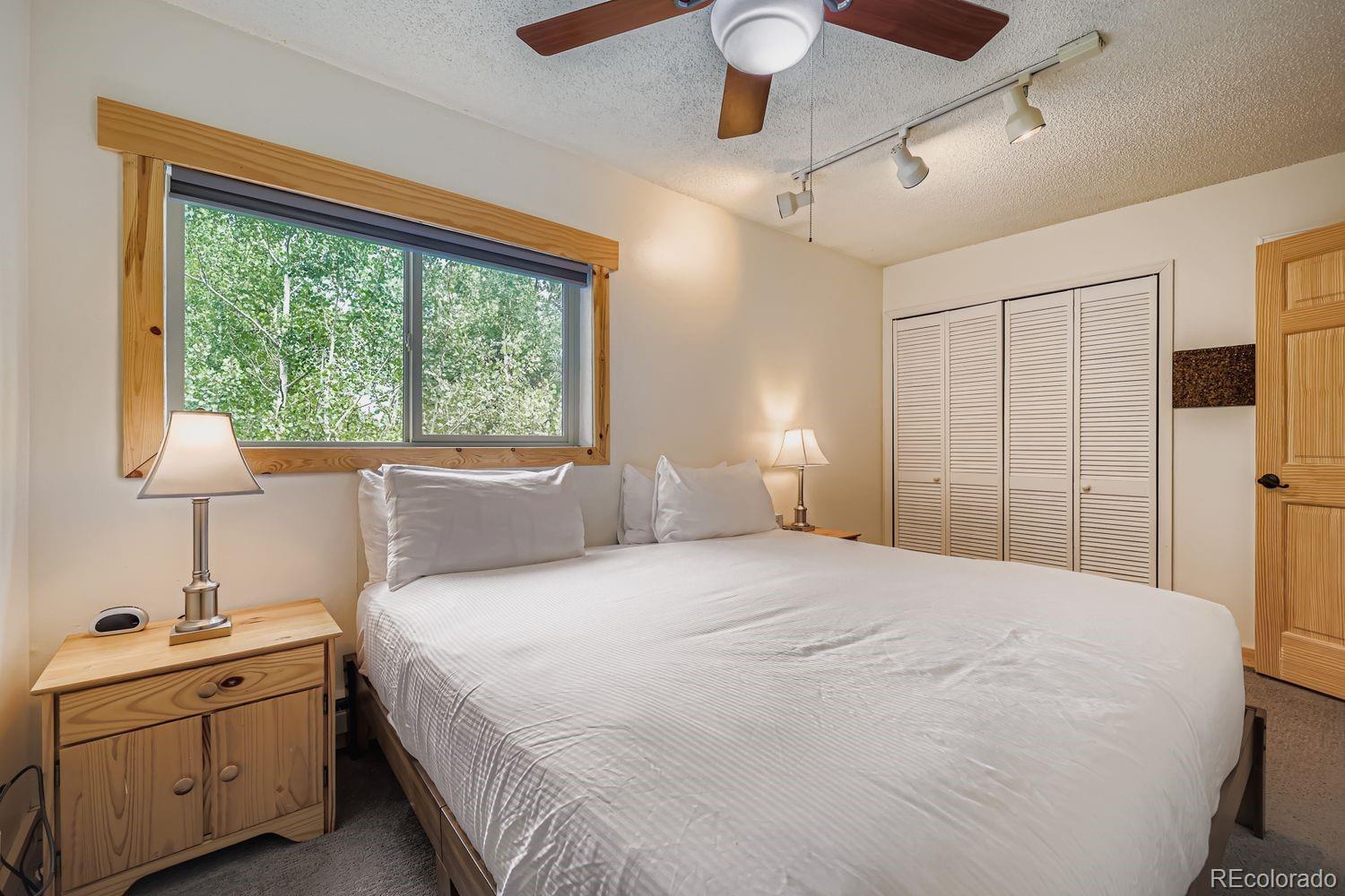 6916 Ryan Gulch Road, Unit 6916 Silverthorne, CO 80498 - Photo 17 of 33 a bedroom with a large bed and a window