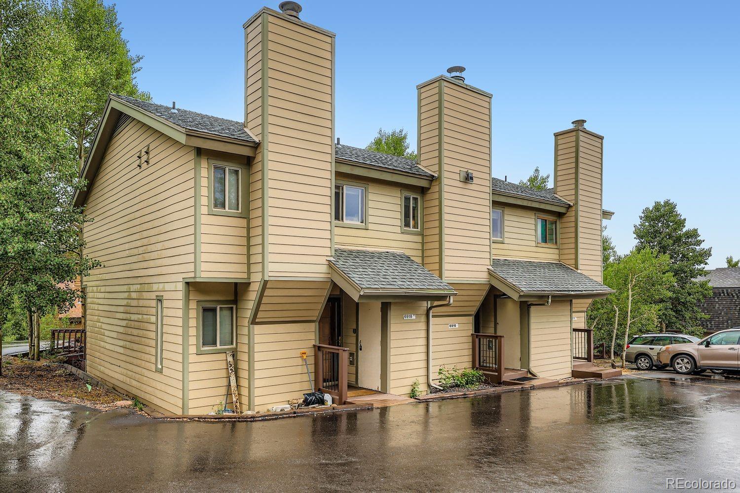 6916 Ryan Gulch Road, Unit 6916 Silverthorne, CO 80498 - Photo 2 of 33 a front view of a house with a yard