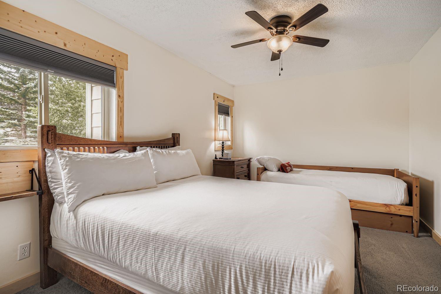 6916 Ryan Gulch Road, Unit 6916 Silverthorne, CO 80498 - Photo 22 of 33 a bedroom with a bed and a large window