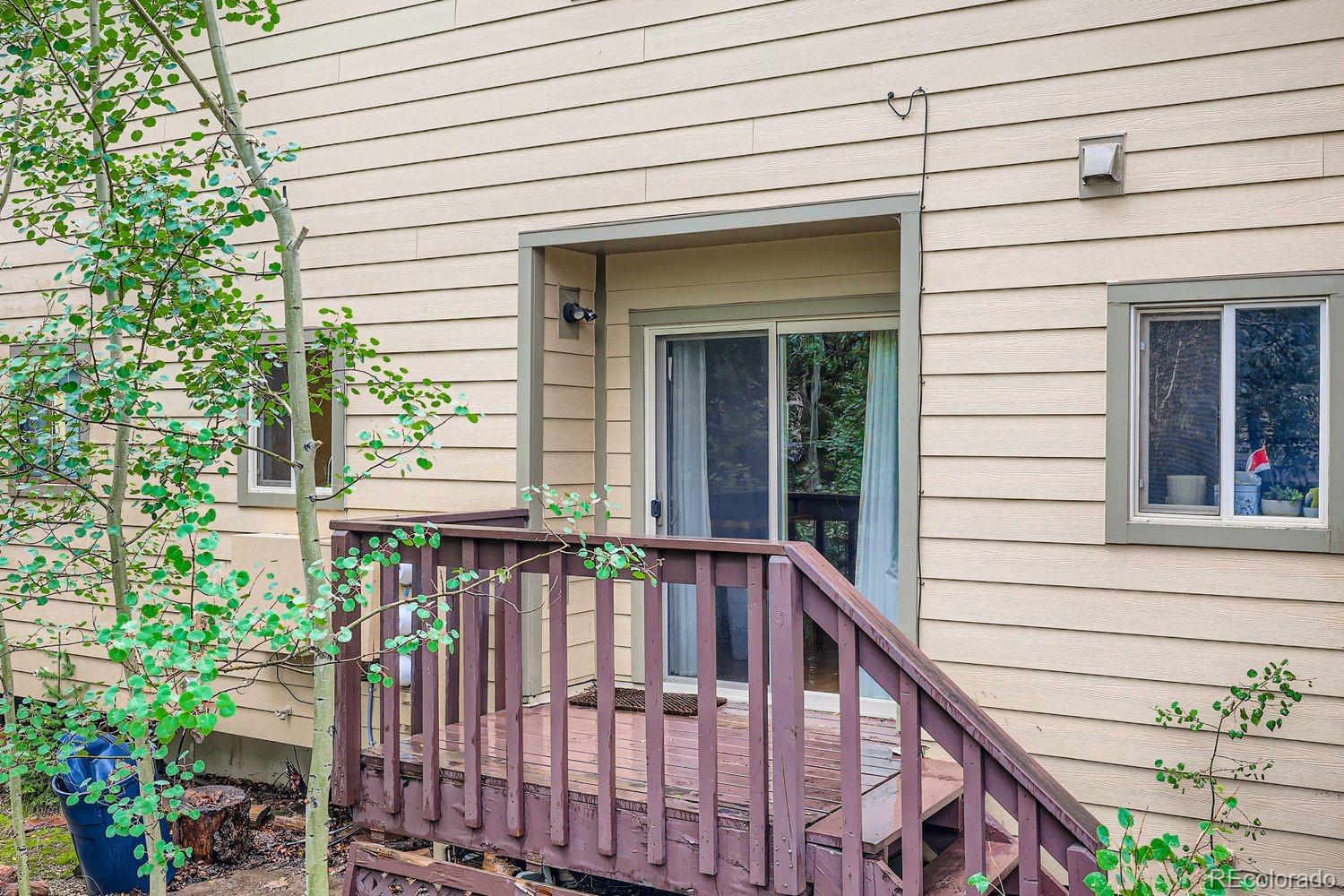 6916 Ryan Gulch Road, Unit 6916 Silverthorne, CO 80498 - Photo 28 of 33 a view of a house with large windows and flower plants